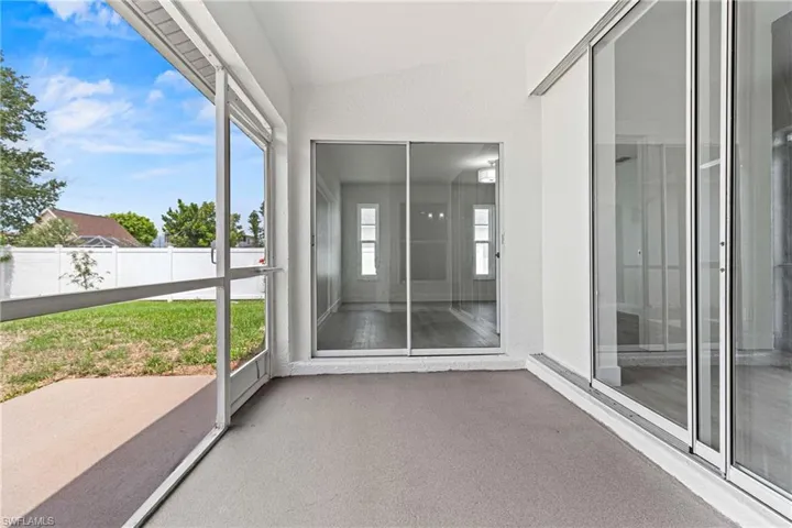 Unfurnished sunroom featuring vaulted ceiling