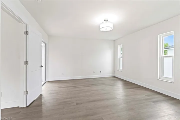 Spare room with dark hardwood / wood-style flooring