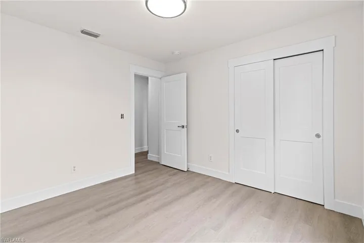 Unfurnished bedroom with a closet and light wood-type flooring