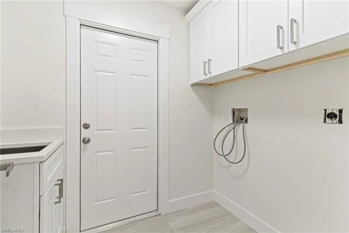 Laundry room featuring cabinets, hookup for an electric dryer, and washer hookup