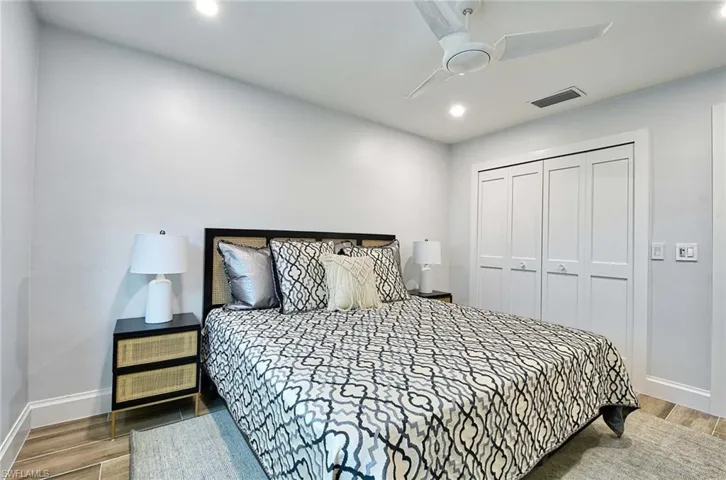 Bedroom with ceiling fan, a closet, and hardwood / wood-style flooring