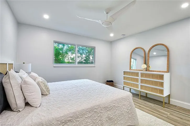 Bedroom with ceiling fan and hardwood / wood-style floors