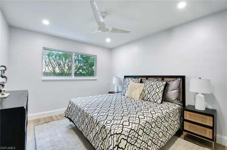 Bedroom featuring ceiling fan and hardwood / wood-style floors