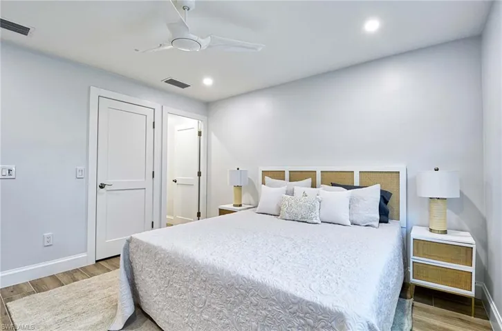 Bedroom featuring ceiling fan and hardwood / wood-style flooring