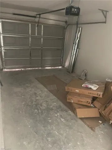 Garage featuring a garage door opener