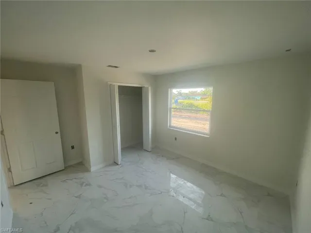 Unfurnished bedroom with light tile patterned floors