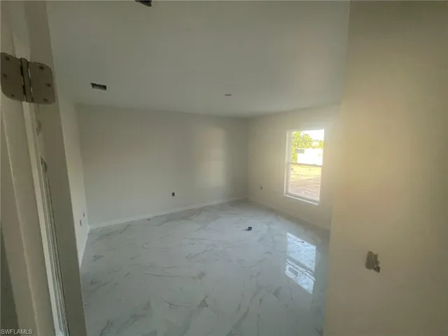 Unfurnished room with light tile patterned floors