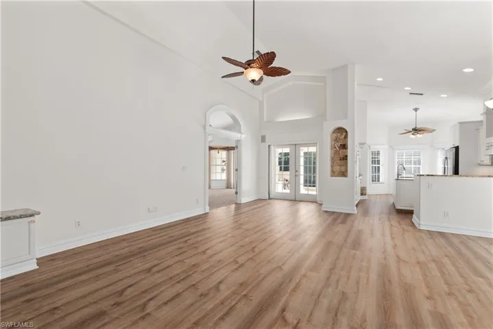 Freshly painted in a neutral white, the main living area boasts a luxury vinyl floor that flows into both the kitchen and the den/office.