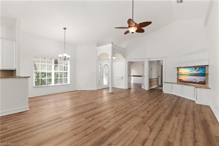 The living room boasts built-ins and a formal eating area. This is a very open floor plan with vaulted ceilings.