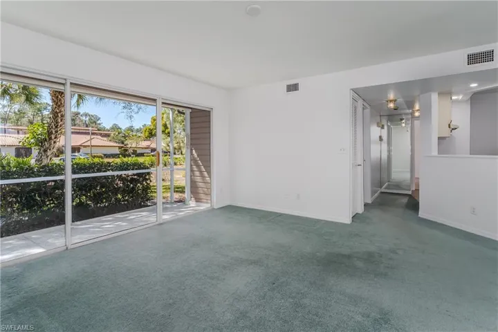Unfurnished room featuring carpet and baseboards