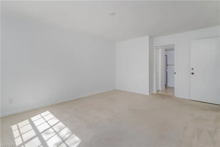 Unfurnished room with light carpet