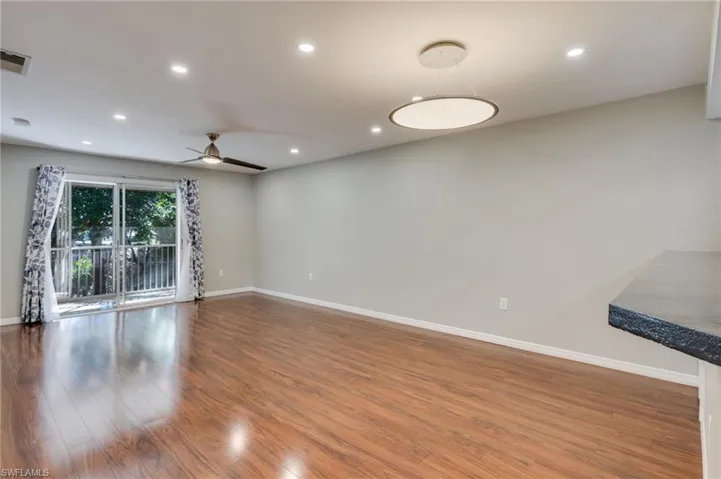 The extremely well-lit living room is also flooded with light from the south-facing lanai and is open to kitchen.