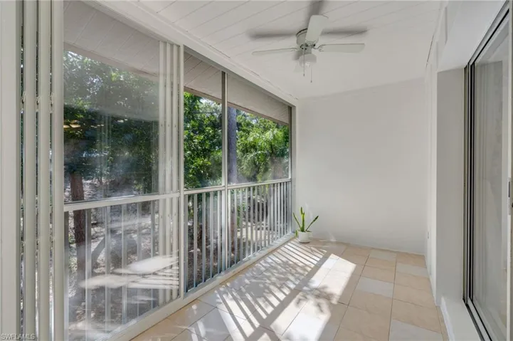 Lanai without virtual staging: The screened lanai features fully retractable, custom-fit fiberglass locking sliders, adding approximately 80 square feet of year-round, temperature-controlled living space.