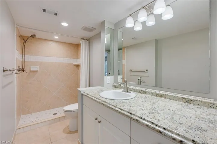 The primary bathroom features new paint, a new faucet, a new LED flush mount light in the shower, and a brand new shower tile floor.