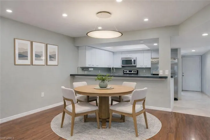 Virtually staged: Open kitchen with dining with new contemporary chandelier and brand new flush mount LED ceiling lighting