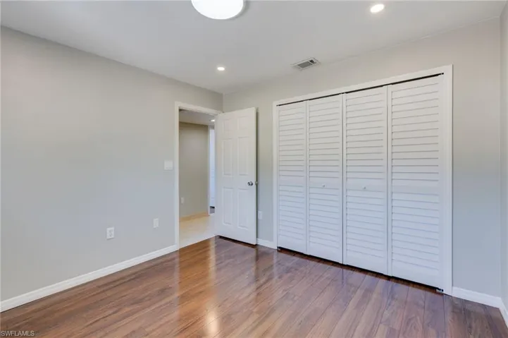 The east bedroom features brand-new oversized bifold doors that open to a spacious closet.