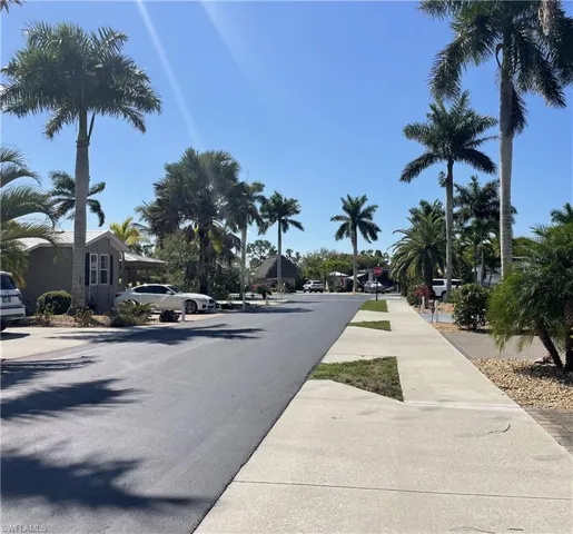 View of asphalt road with sidewalks and traffic signs