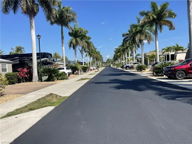 View of asphalt street with street lights