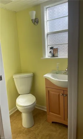 Half bathroom with vanity and toilet