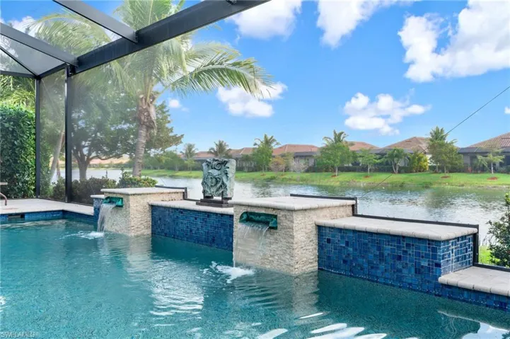 Pool featuring a lanai, a patio area, and a water view