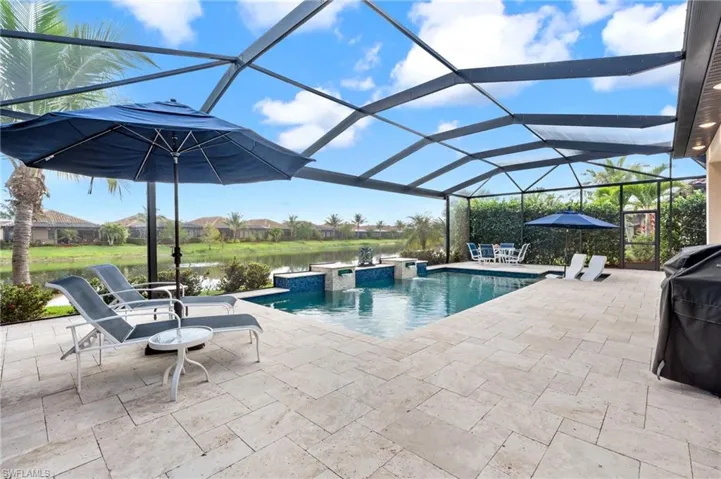 Outdoor pool featuring a lanai, a patio area, and a jacuzzi