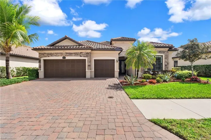 Mediterranean / spanish home featuring stone siding, a tile roof, an attached garage, decorative driveway, and stucco siding