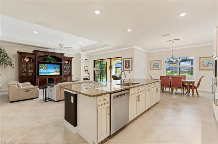 Kitchen featuring a sink, a healthy amount of sunlight, crown molding, and stainless steel dishwasher