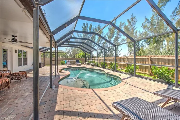Additional view featuring an oversized patio, covered rear porch with fan, and a fenced backyard for privacy.