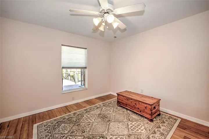 Bedroom 3 with ceiling fan, baseboards, and bamboo wood floors.