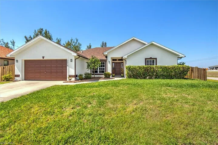 A place to call home that has been freshly painted sitting on a corner lot with updated shingle roof, and front yard.