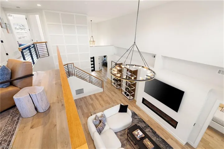 Living area with light wood finished floors and a chandelier