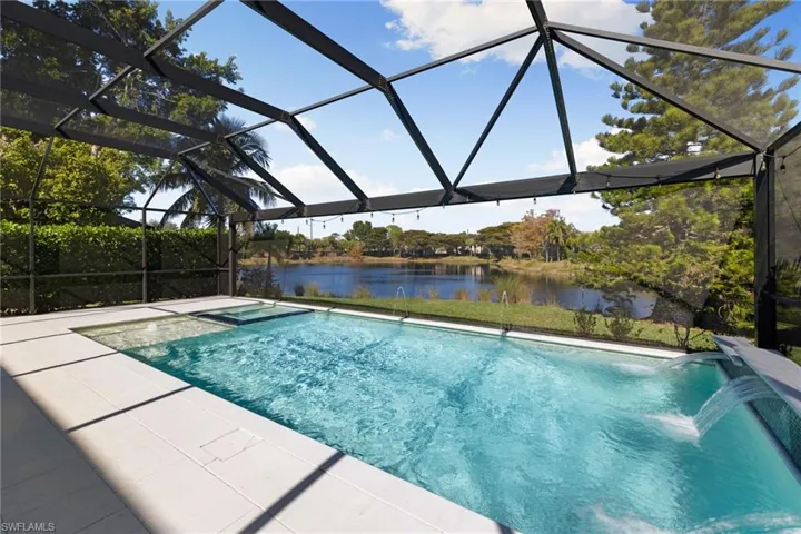 Outdoor pool featuring a sunroom, a lanai, and a water view