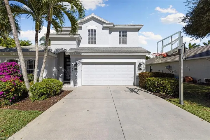 View of front of property featuring stucco siding, driveway, and an attached garage