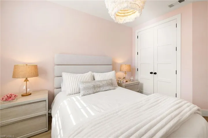 Bedroom featuring a closet and a chandelier