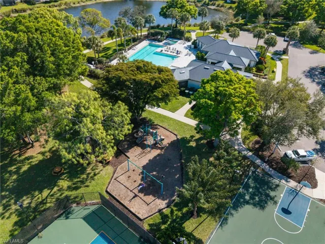 Aerial view of a pool area and a large body of water