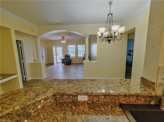 Kitchen with separate washer and dryer, a breakfast bar, light hardwood / wood-style flooring, stainless steel refrigerator with ice dispenser, and sink