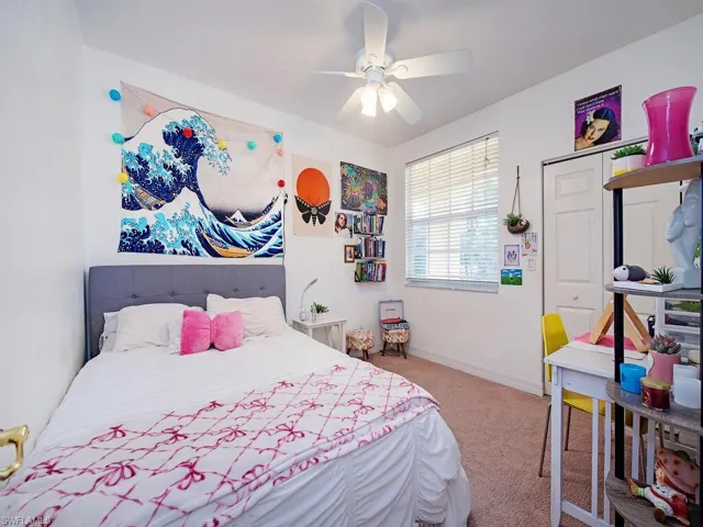 Bedroom with light carpet and ceiling fan