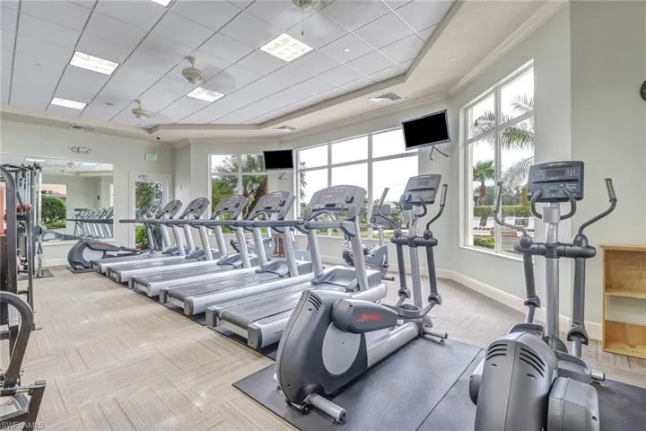 Gym with crown molding and a paneled ceiling