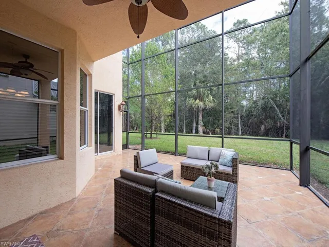 View of patio / terrace featuring a ceiling fan, a sunroom, and outdoor lounge area