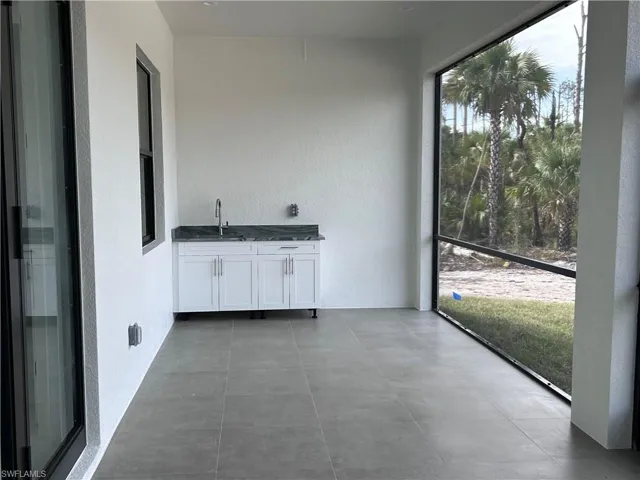 Unfurnished sunroom featuring sink