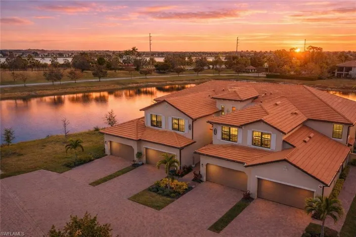 Mediterranean / spanish-style house featuring a water view, stucco siding, driveway, and a tiled roof