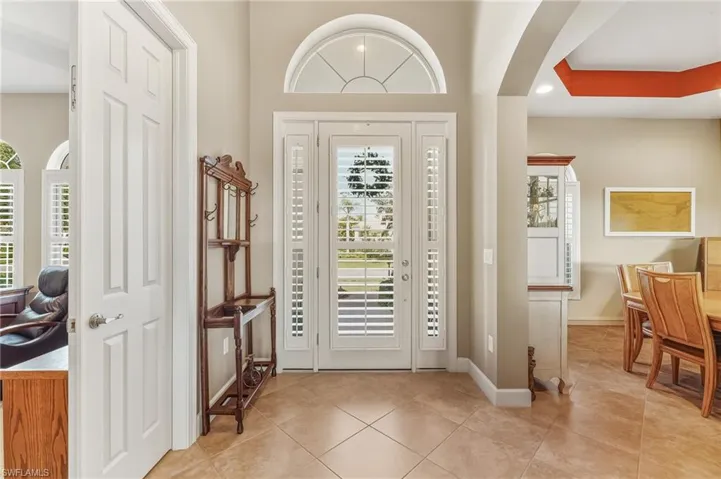 Front door with glass inserts & transom window allows for more natural light.