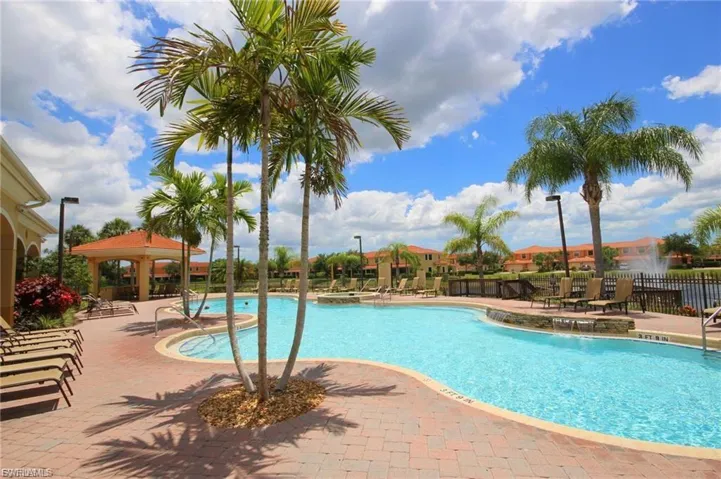 Large swimming pool with a freeform design, surrounded by a paver deck