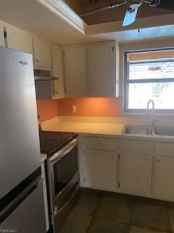 Kitchen with stainless steel refrigerator and cook top stove.