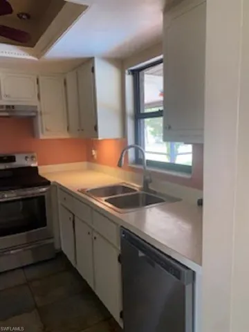 Kitchen featuring a sink, light cabinets and countertops.
