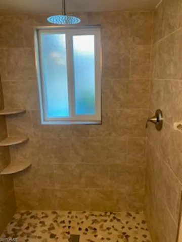 Bathroom # 2 featuring walk in tiled shower.