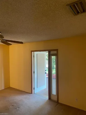 Carpeted master bedroom with French Door access to lanai.
