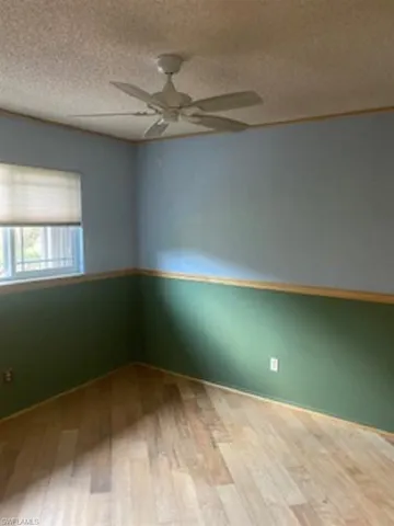 Bedroom # 3 with hardwood floors and ceiling fan.