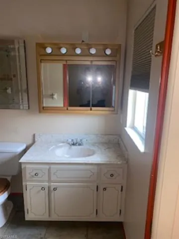 Master Master Bathroom featuring toilet, vanity, and tile floor.