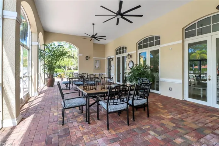 View of patio featuring outdoor dining area and ceiling fan